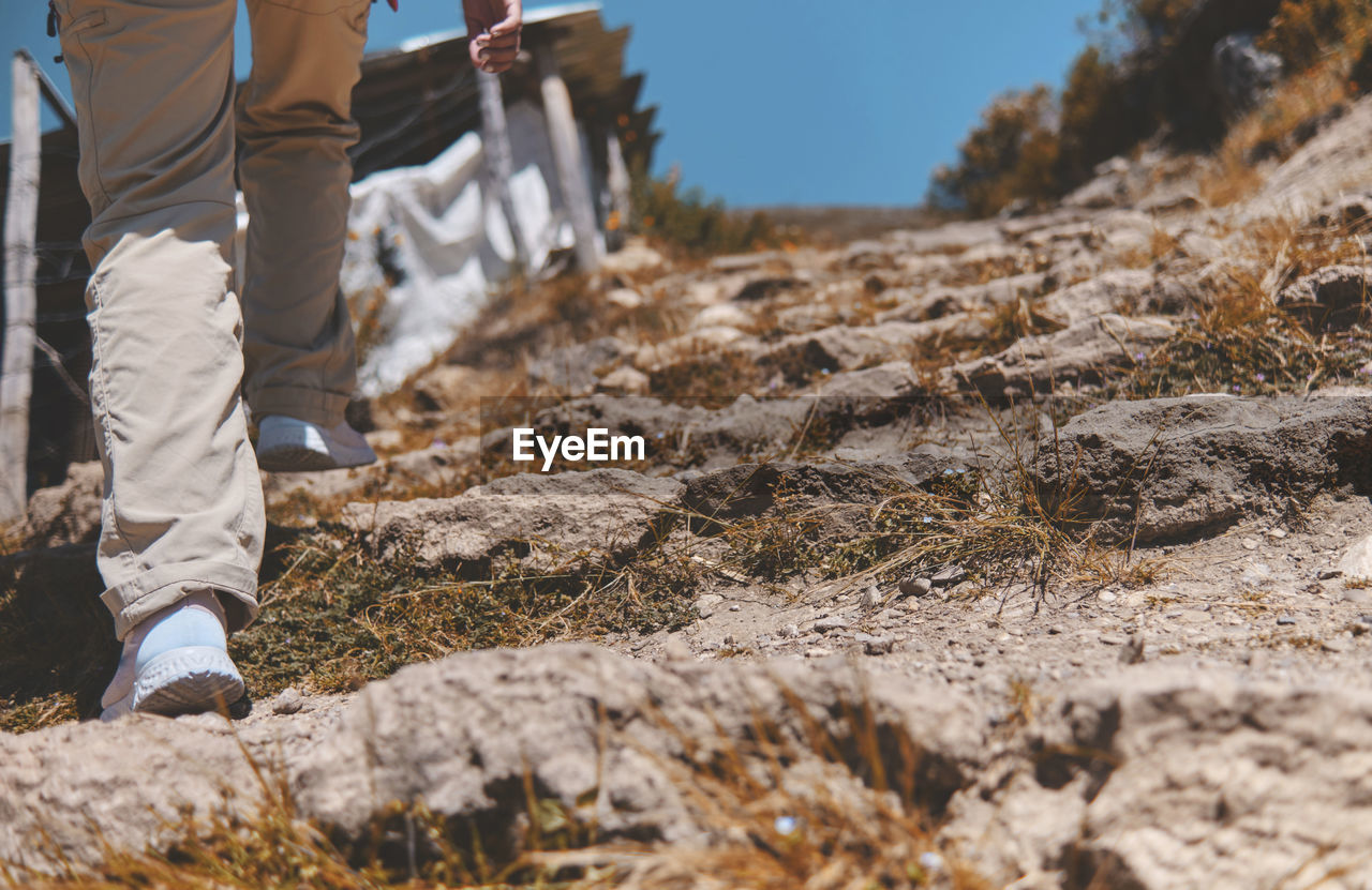 Young tourist walks on a path to the mountain. adventure travel, hiking concept