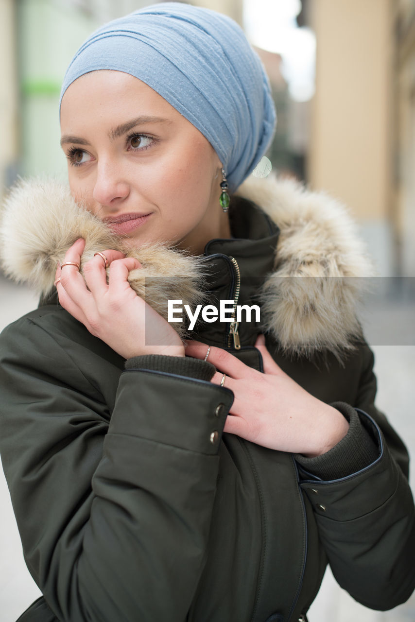 Young woman wearing jacket and hijab