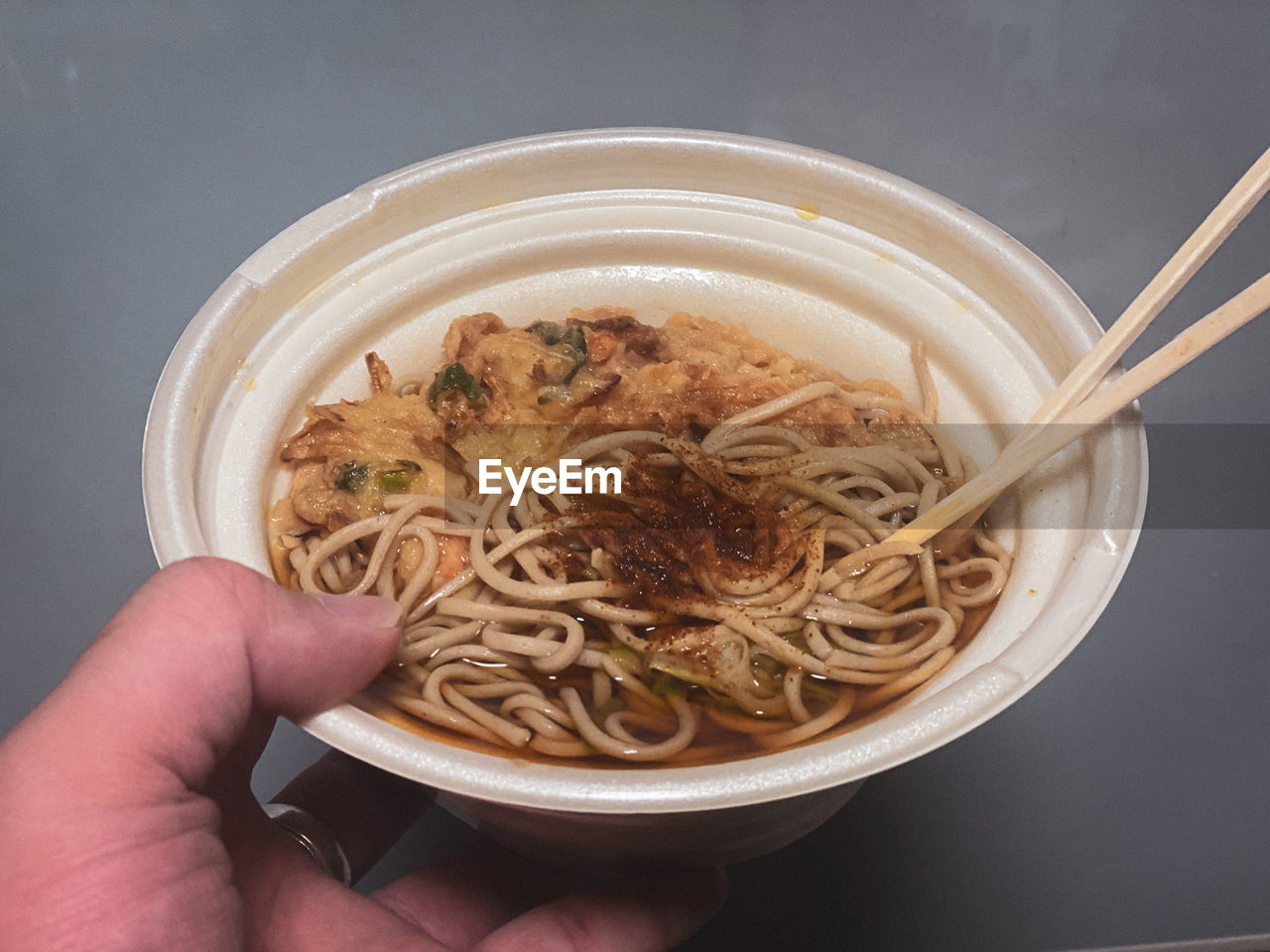 MIDSECTION OF PERSON HOLDING BOWL OF SOUP