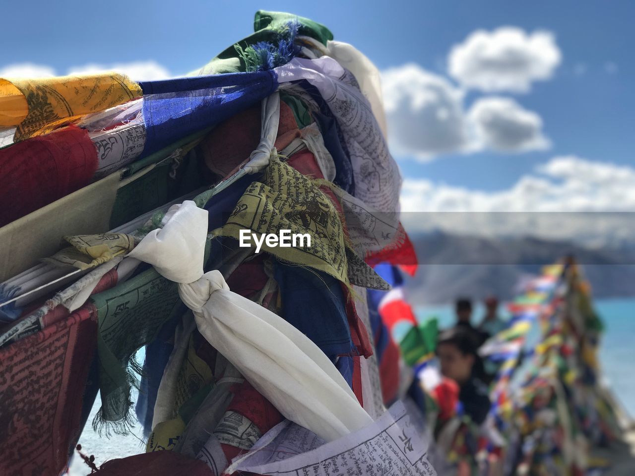 CLOSE-UP OF FLAGS AGAINST SKY