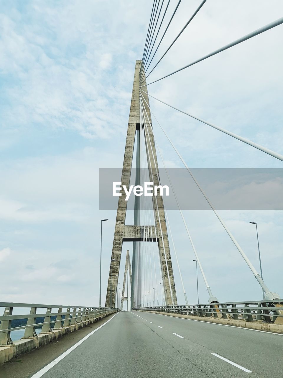 Low angle view of suspension bridge against sky