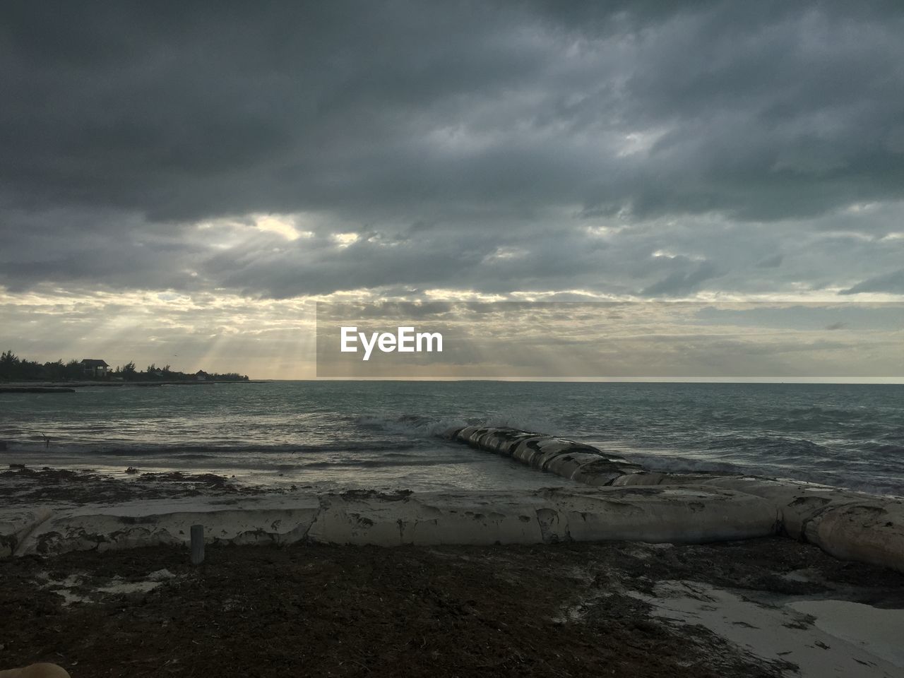 Scenic view of beach against sky during sunset