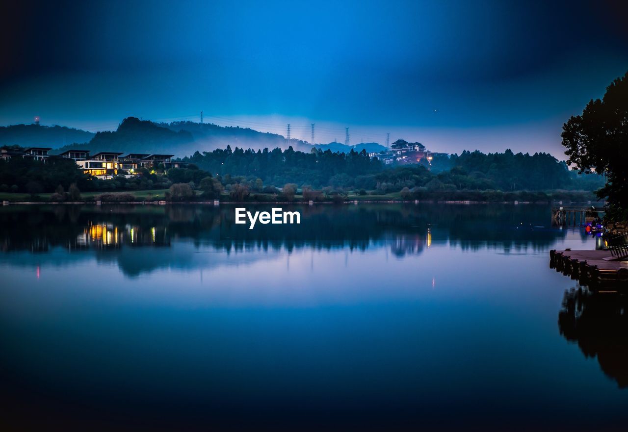 Scenic view of lake against sky at night