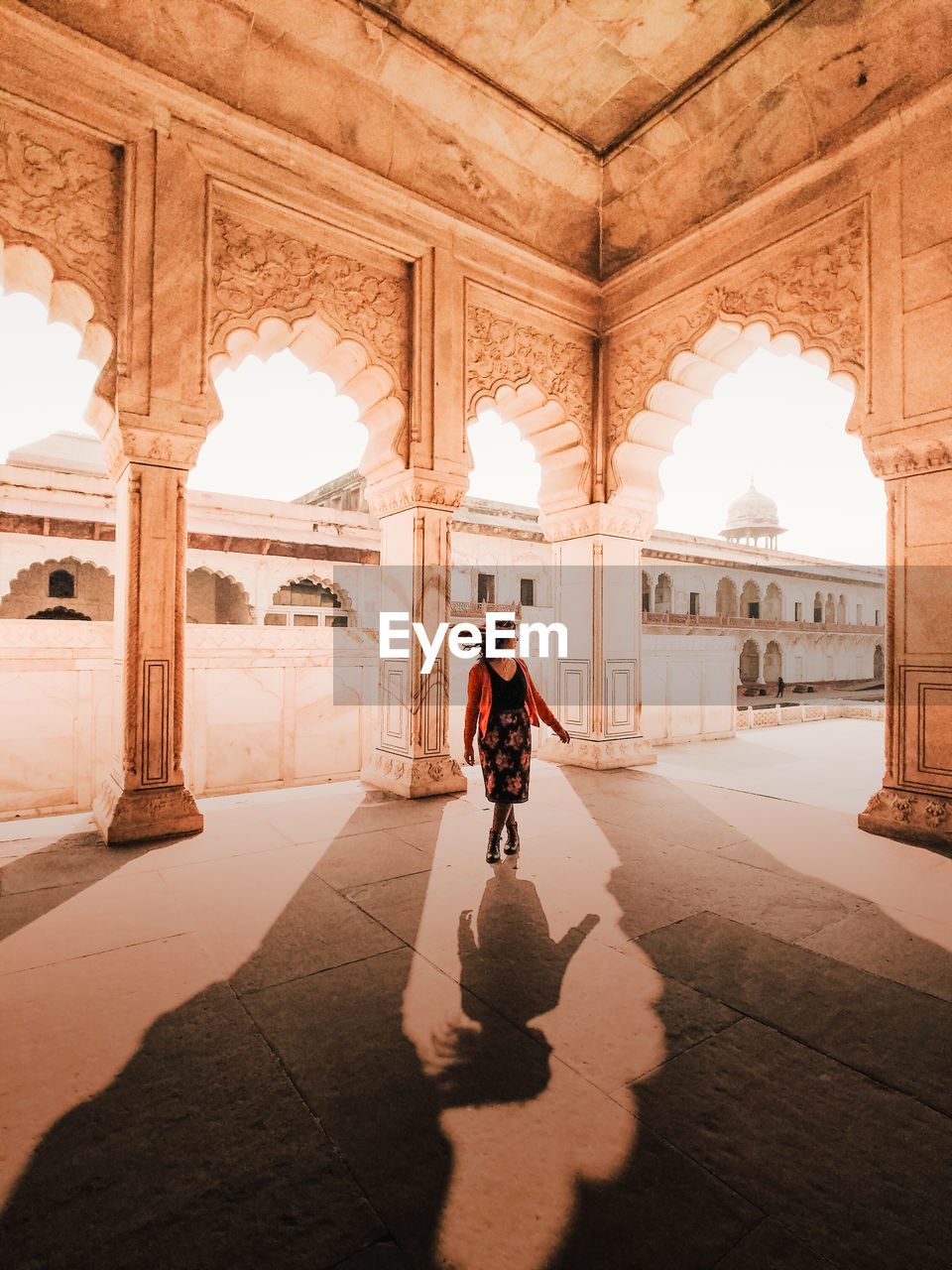 FULL LENGTH OF WOMAN WALKING IN HISTORIC BUILDING