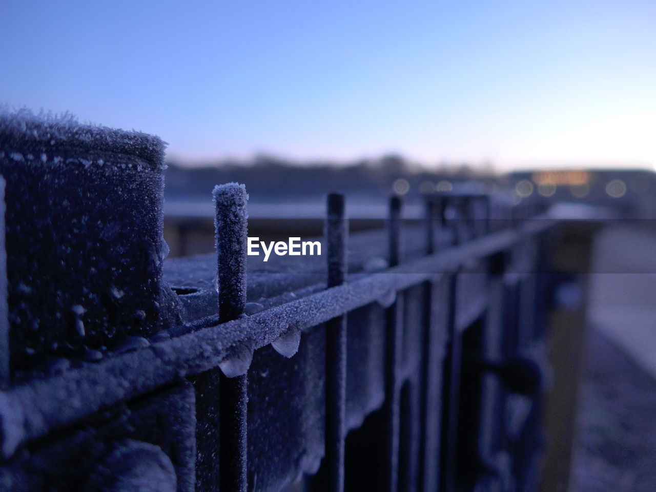 Close-up of wooden post during winter against sky