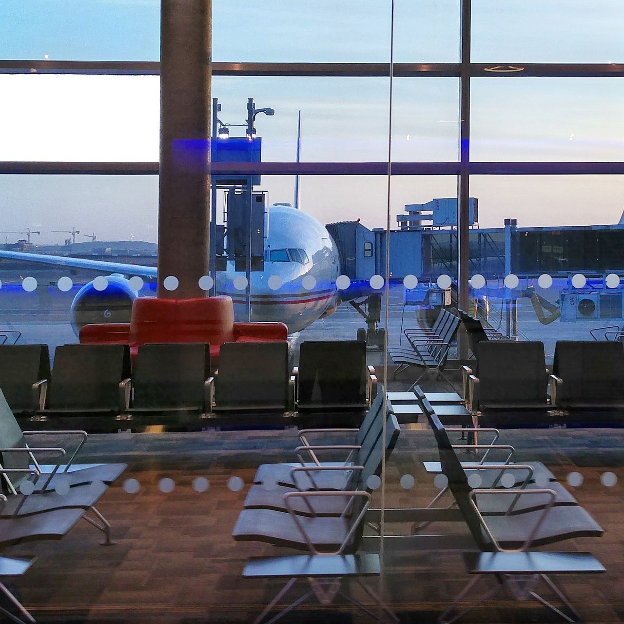 Empty chairs in lobby at airport