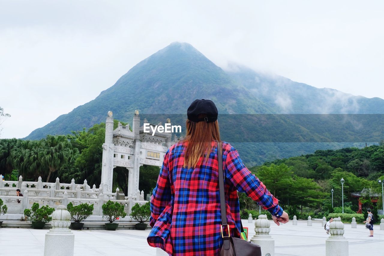 Rear view of young woman at temple