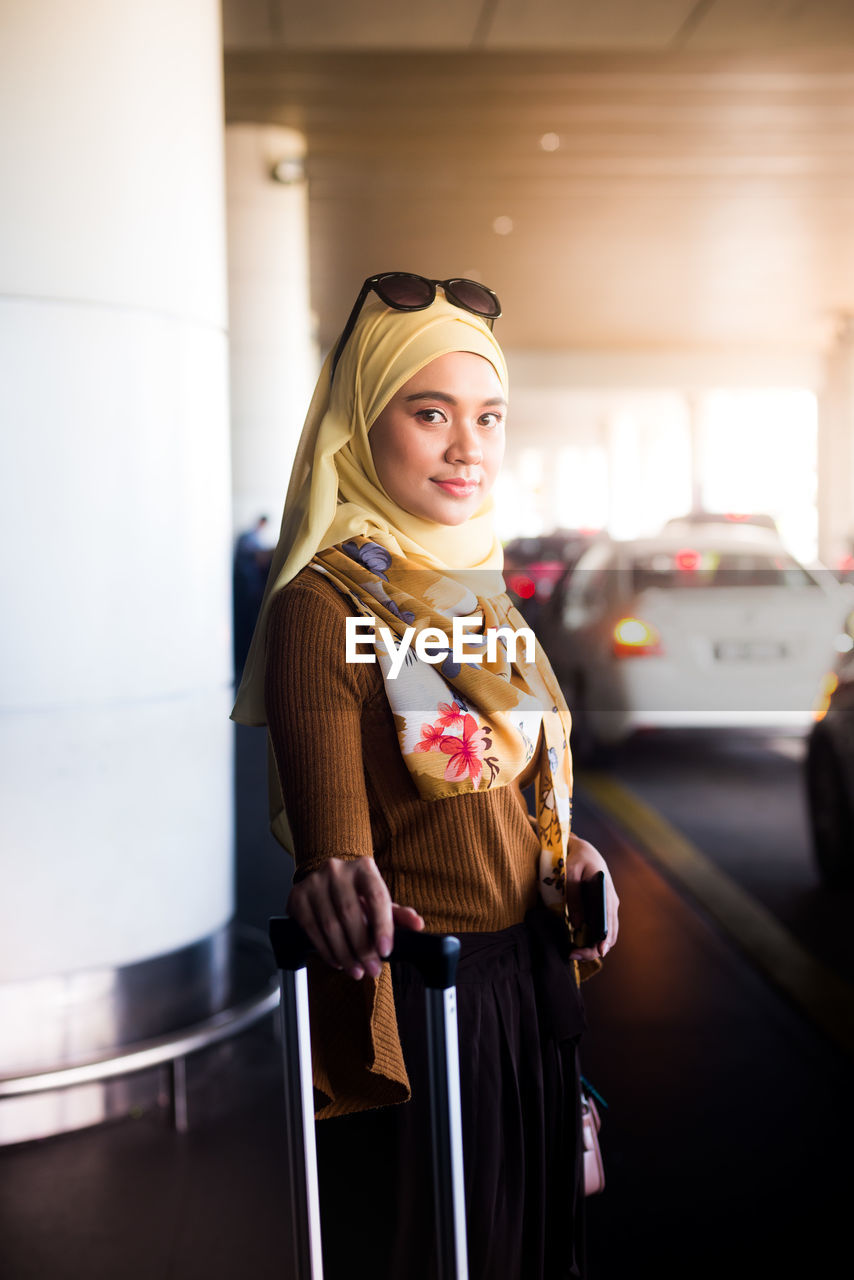 Portrait of woman standing at airport