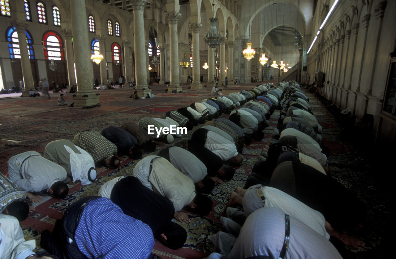 Men offering prayers at mosque