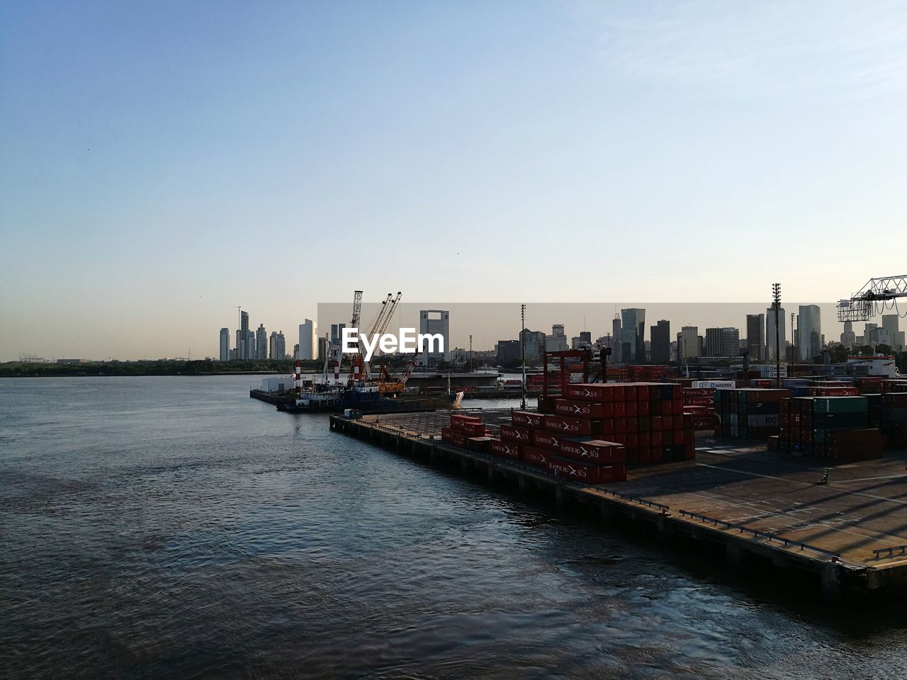 CITY AT WATERFRONT AGAINST CLEAR SKY