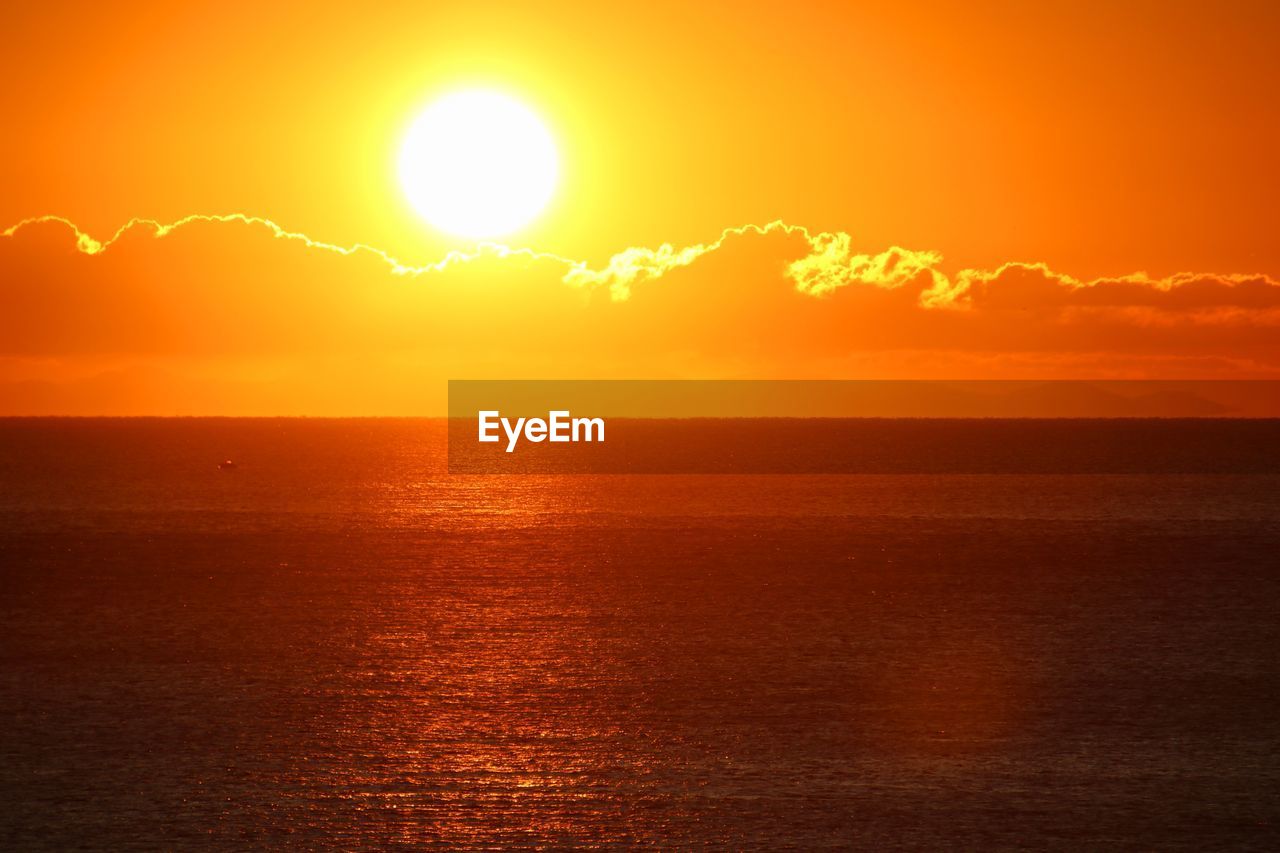 SCENIC VIEW OF SEA AGAINST ORANGE SKY DURING SUNSET