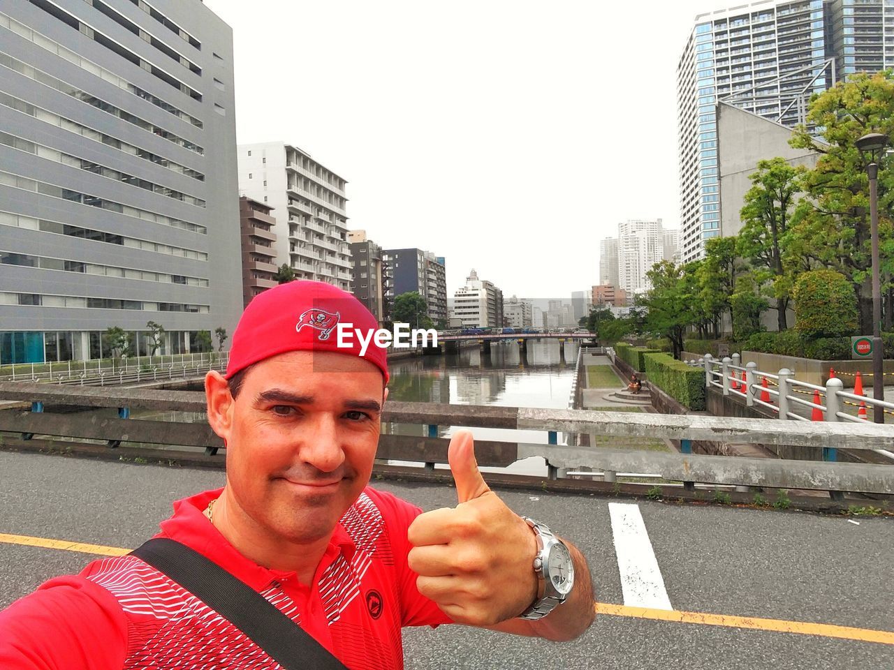 PORTRAIT OF SMILING MAN STANDING ON ROAD