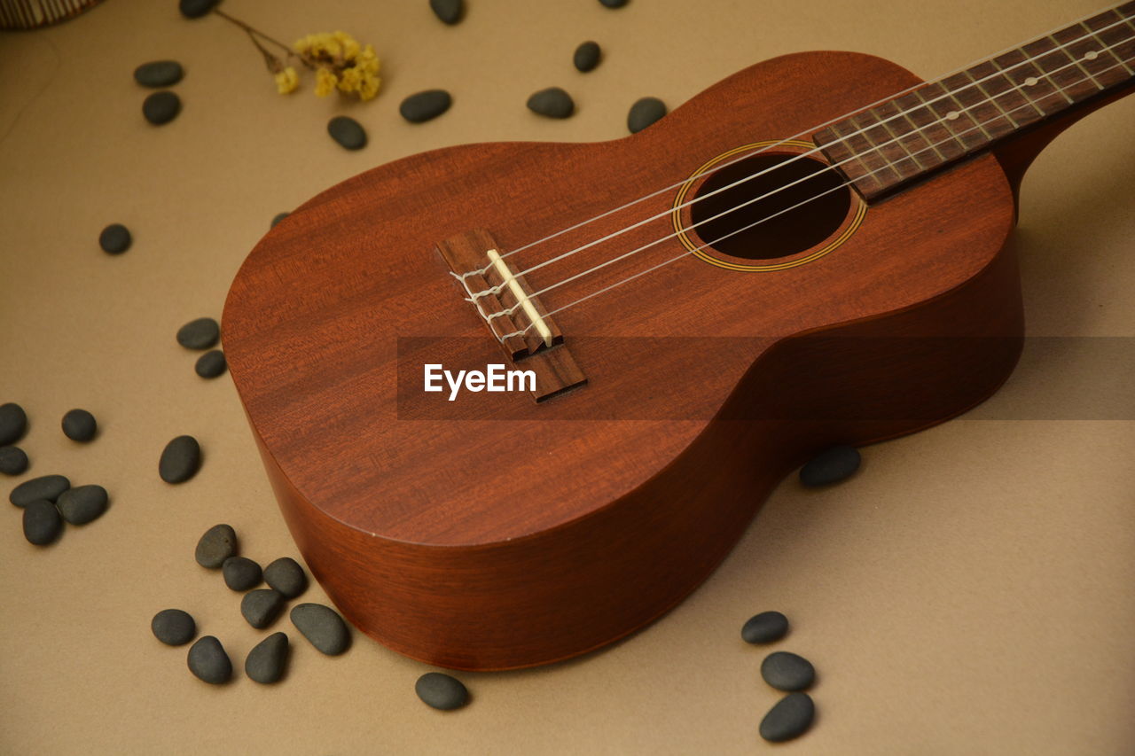 Close-up of guitar and pebbles on table