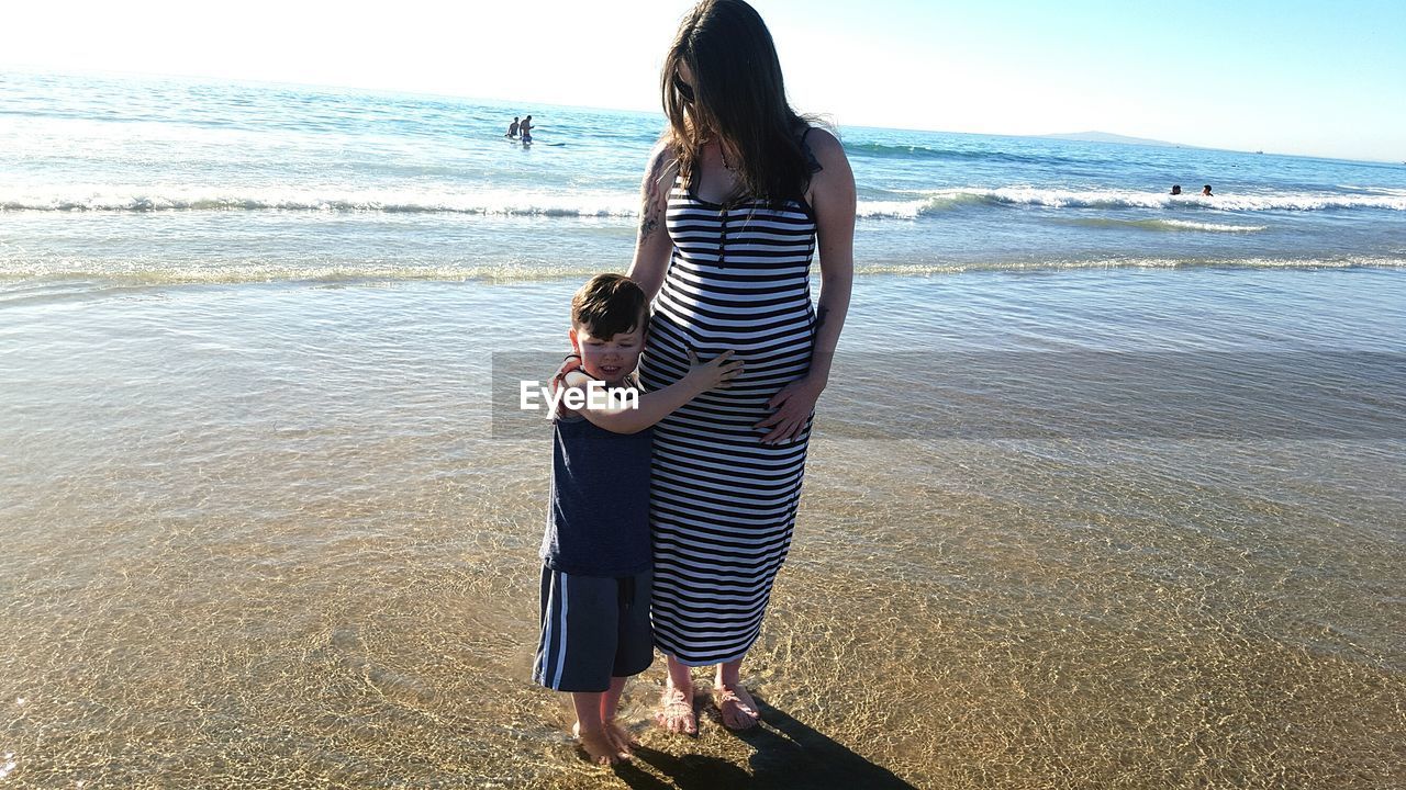 WOMAN WALKING ON BEACH