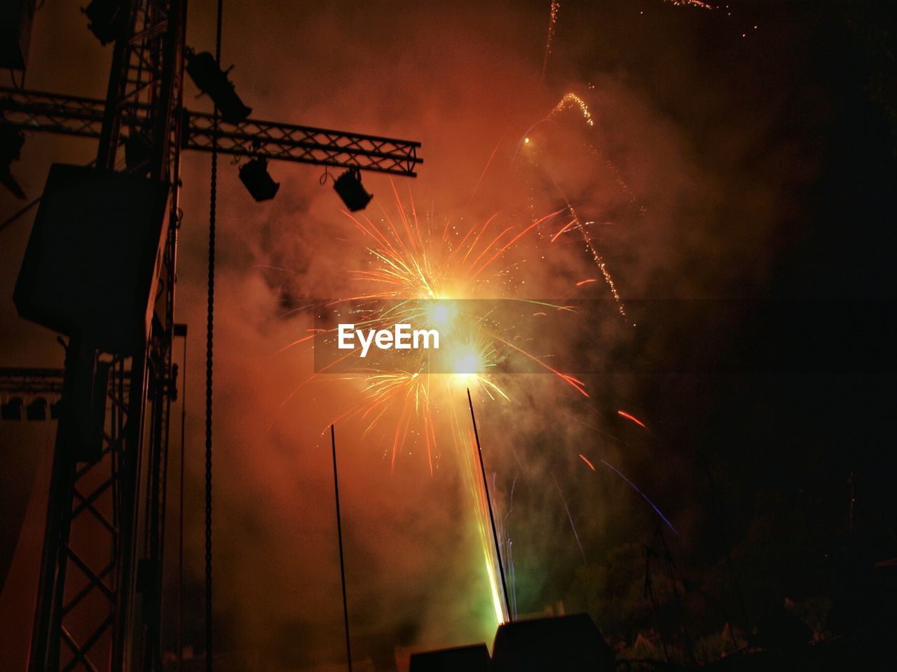 Low angle view of fireworks exploding at night