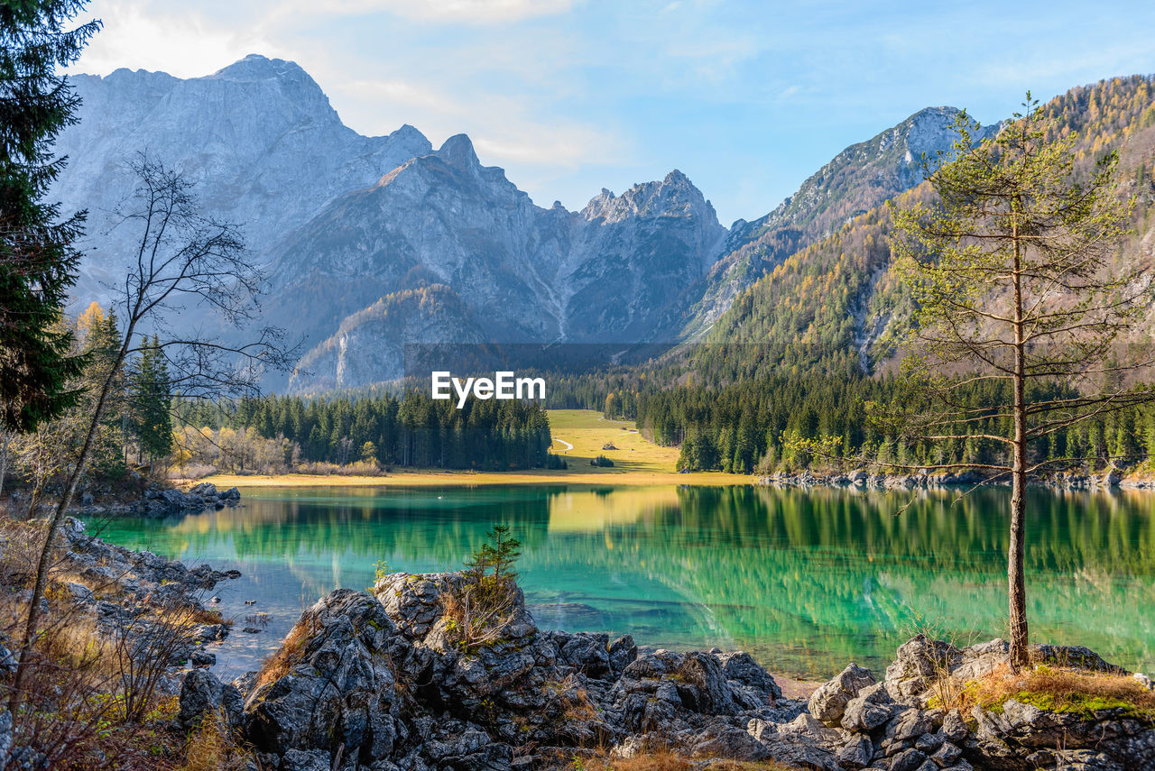 Amazing alpine lake under mountains on a sunny day in autumn
