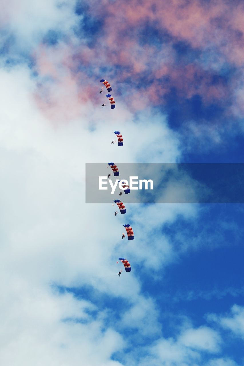 LOW ANGLE VIEW OF AIRSHOW IN MID-AIR AGAINST SKY