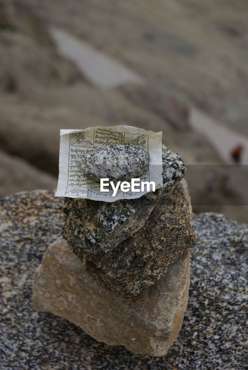 High angle view of paper and rocks