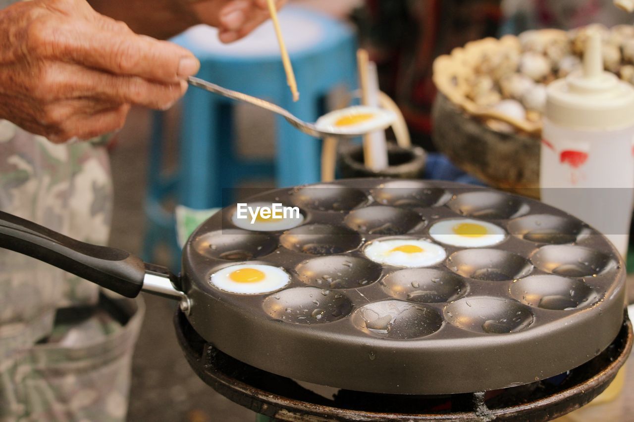 Cropped hand of man preparing food