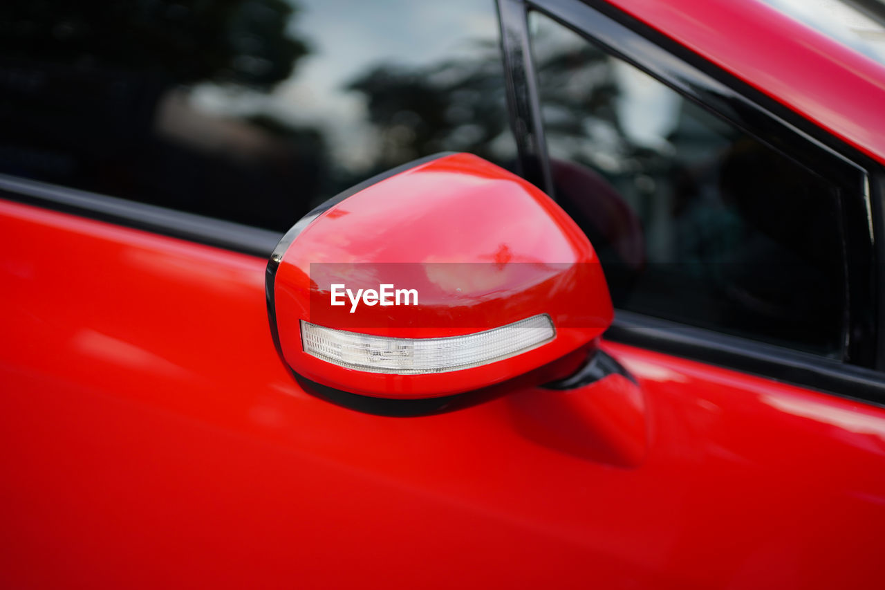 Close up of modern red car mirror