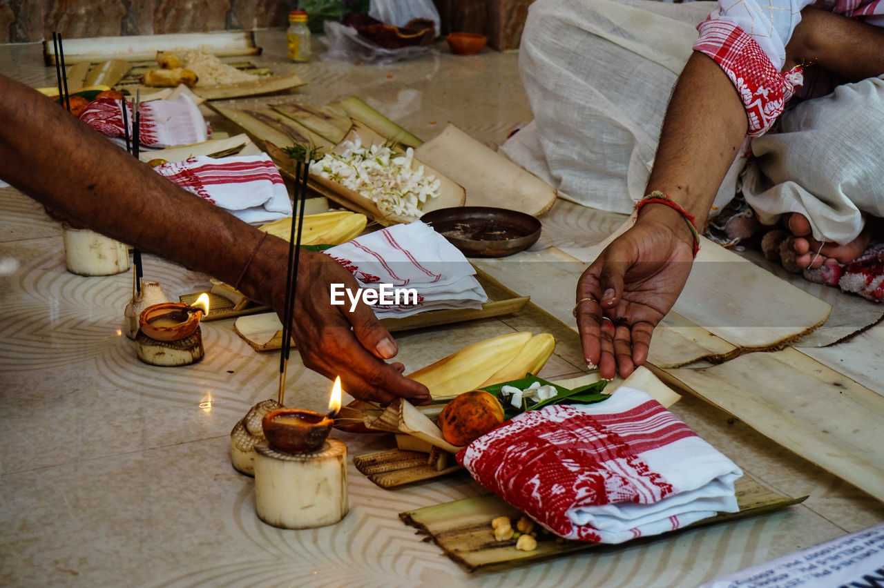 Cropped image of people during puja