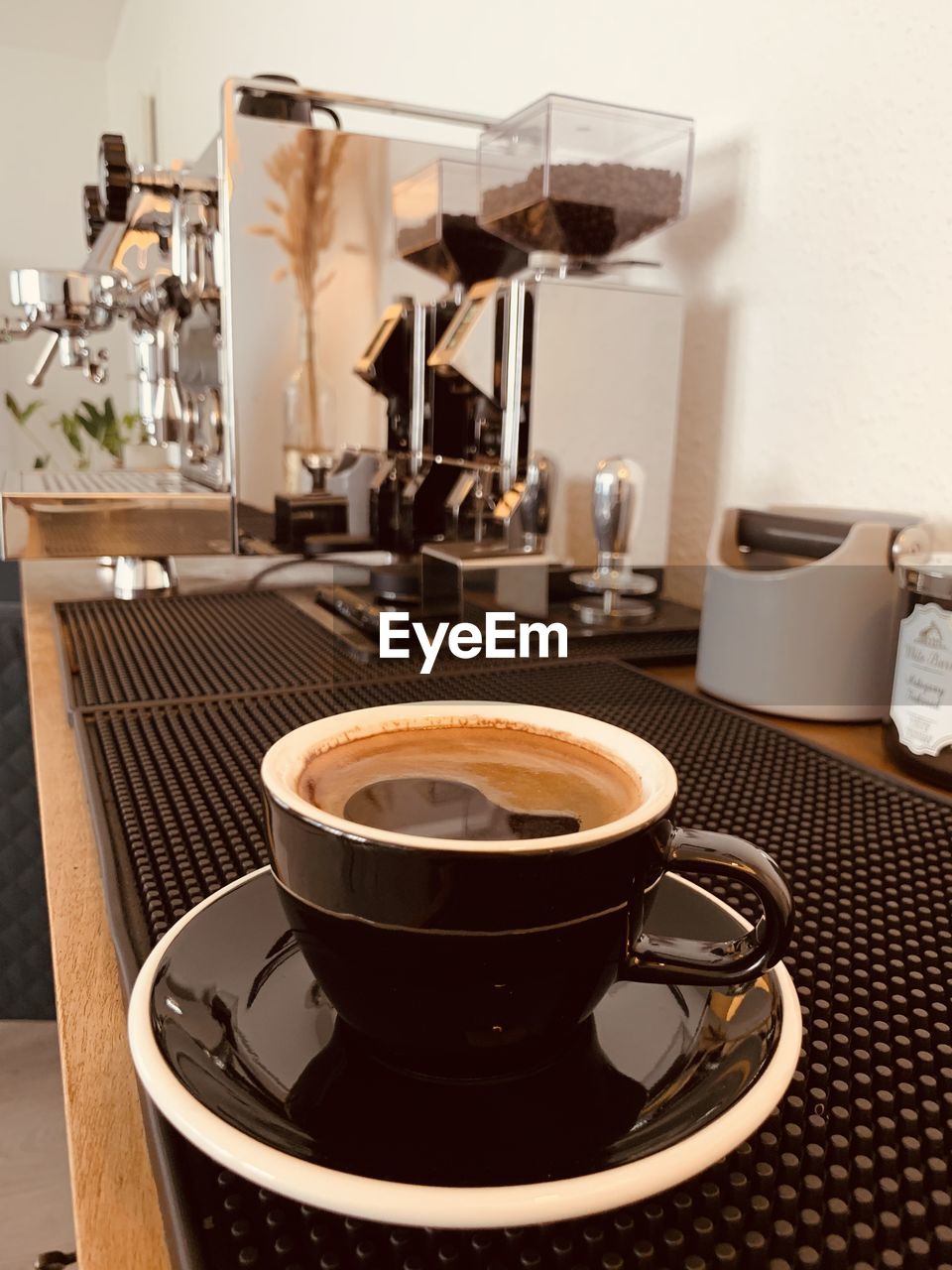 CLOSE-UP OF COFFEE CUP ON TABLE AT CAFE