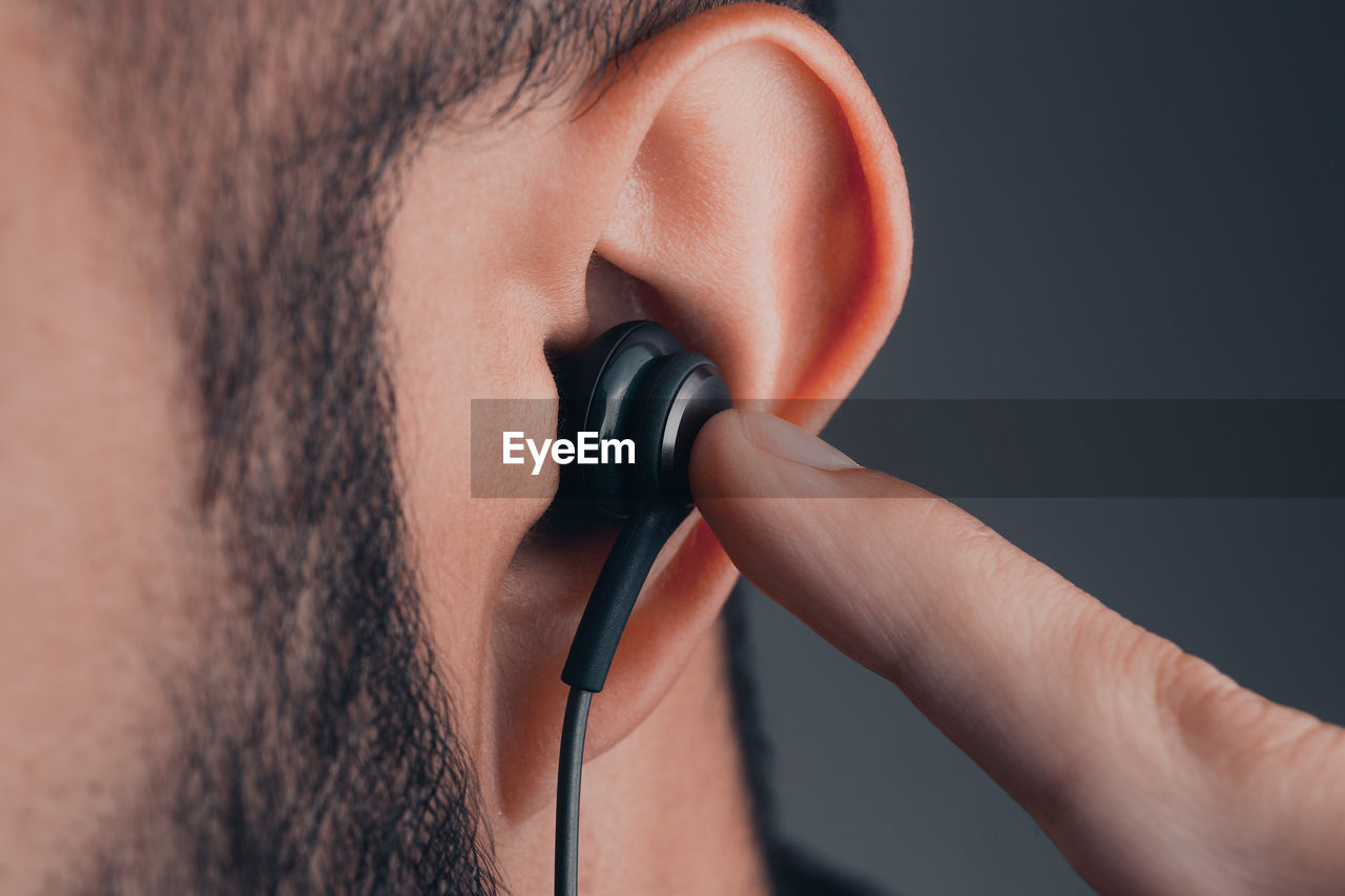 Close-up of man hand holding headphone