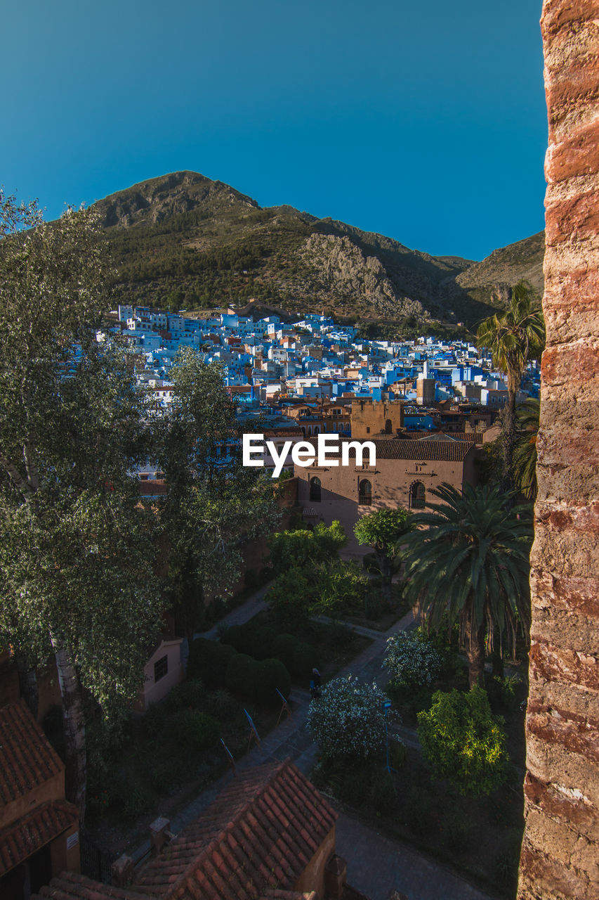 High angle view of town against clear blue sky