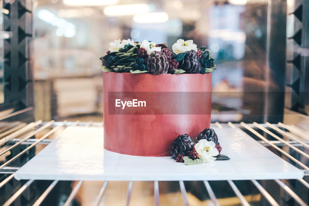 CLOSE-UP OF FRESH FRUITS ON TABLE IN CONTAINER