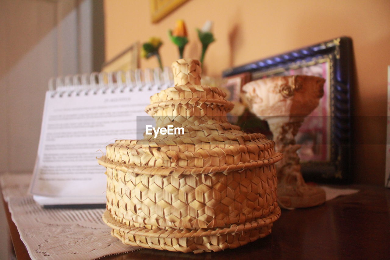 CLOSE-UP OF CAKE ON TABLE AGAINST WALL