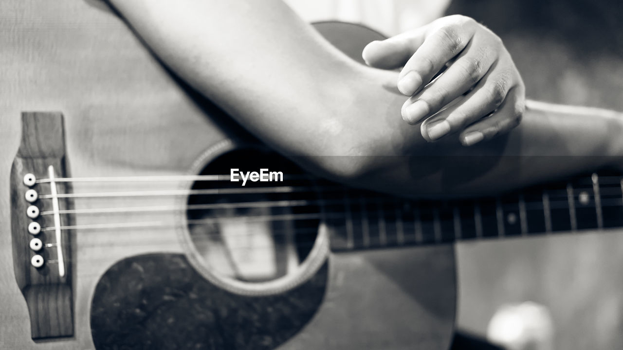 Close-up of man holding guitar