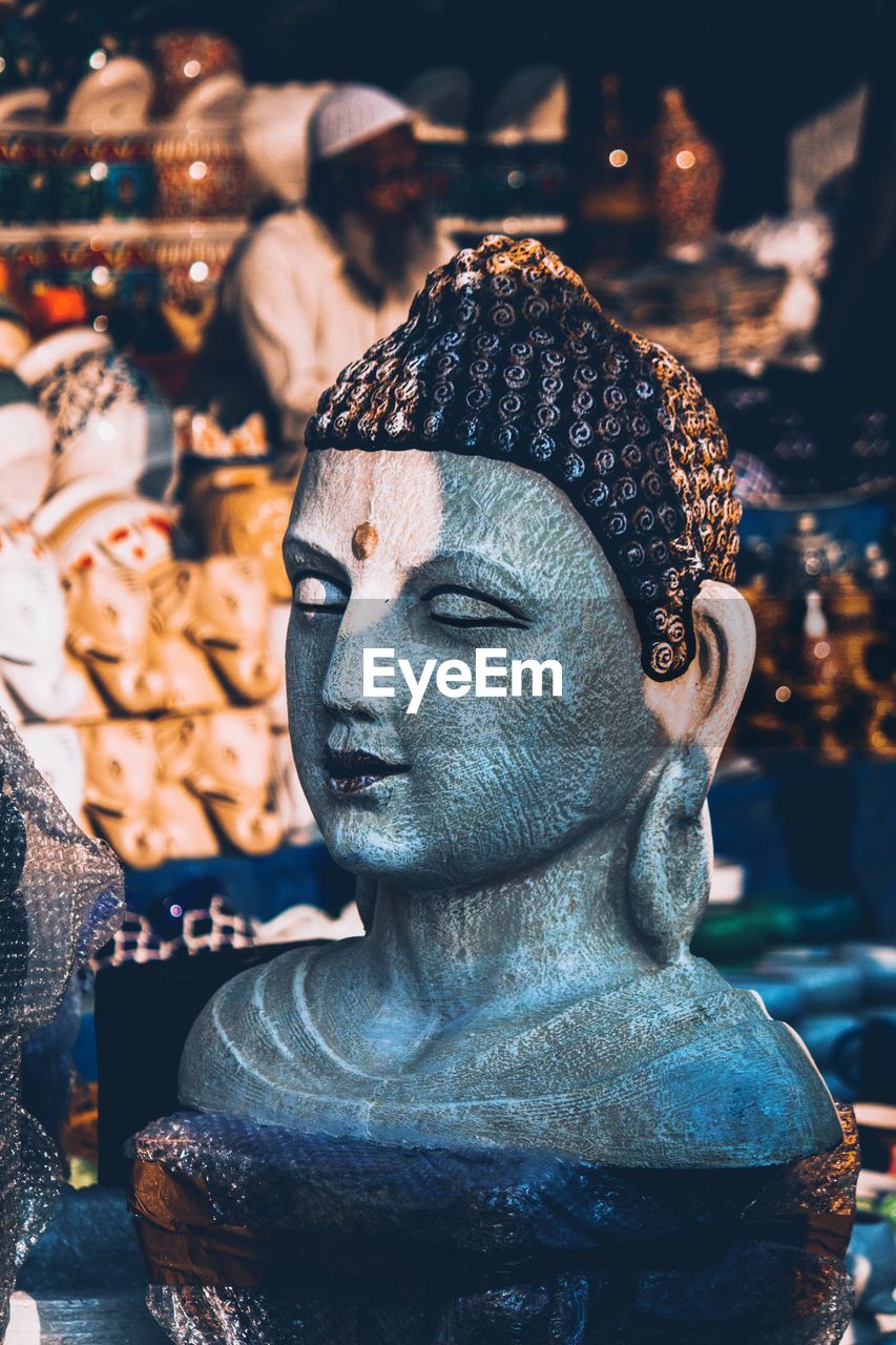 CLOSE-UP OF BUDDHA STATUES