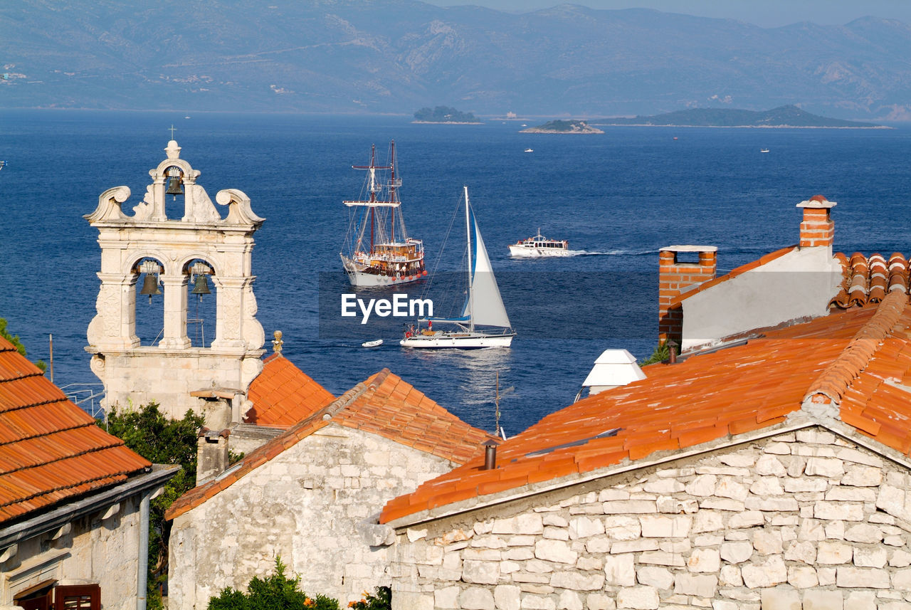 HIGH ANGLE VIEW OF BUILDINGS AGAINST SEA