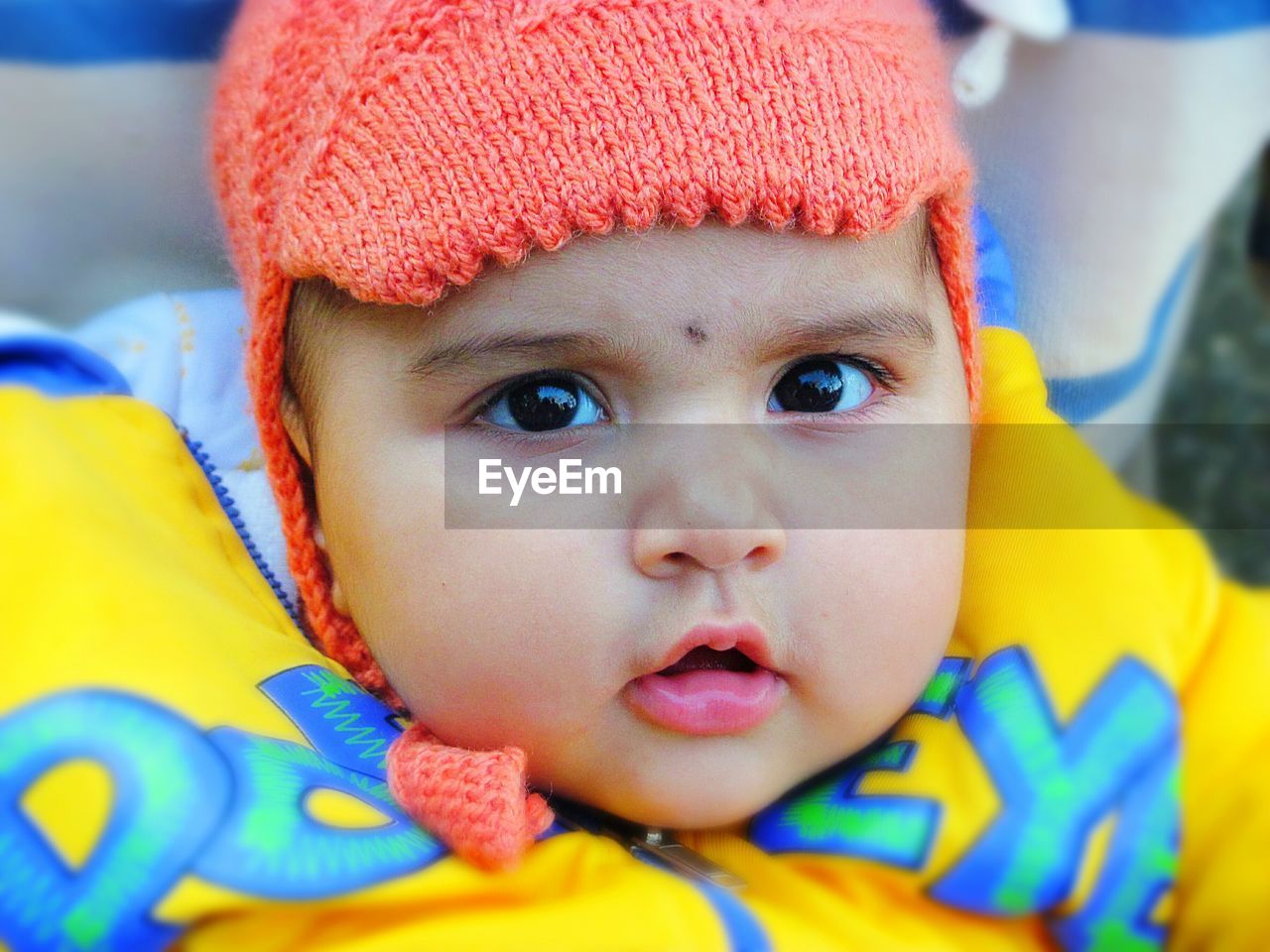Close-up portrait of cute baby girl wearing knit hat