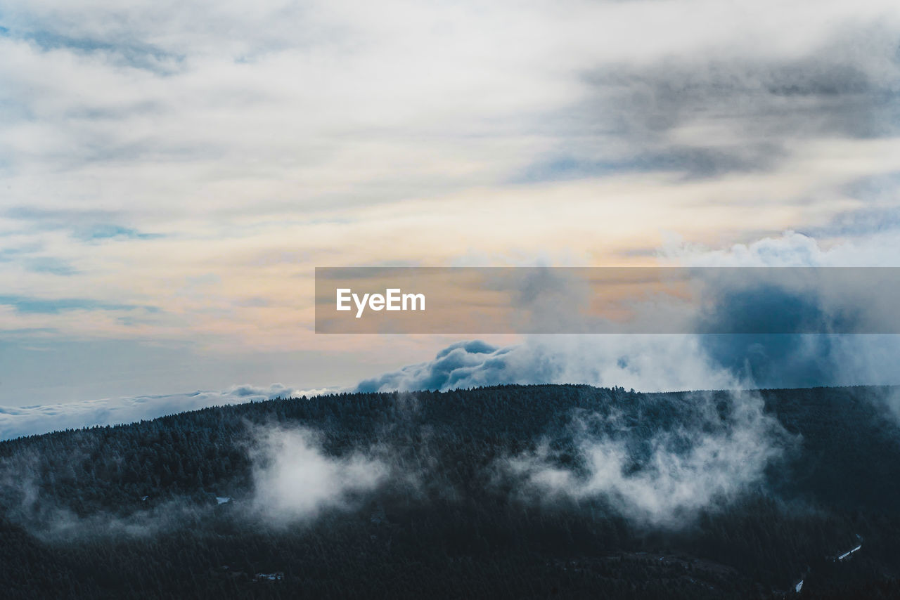 Scenic view of clouds over mountain against sky