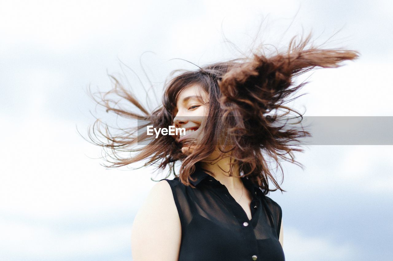 Portrait of beautiful woman against sky