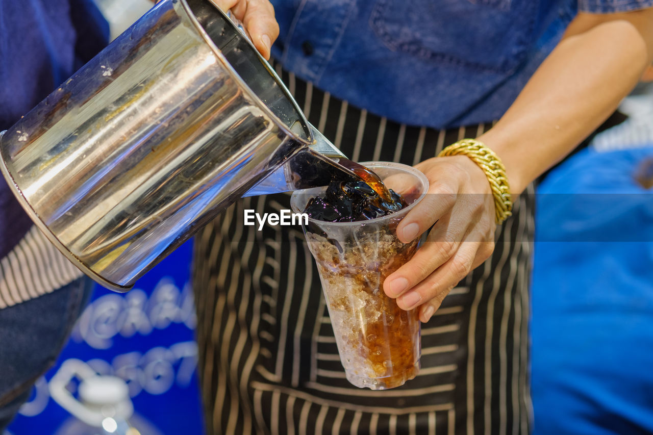 Close-up of hand holding iced coofer