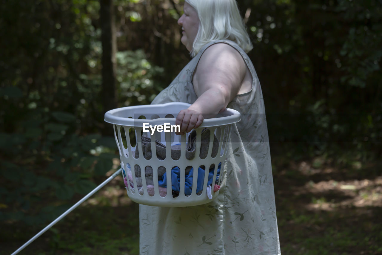Blind woman carrying a laundry basket