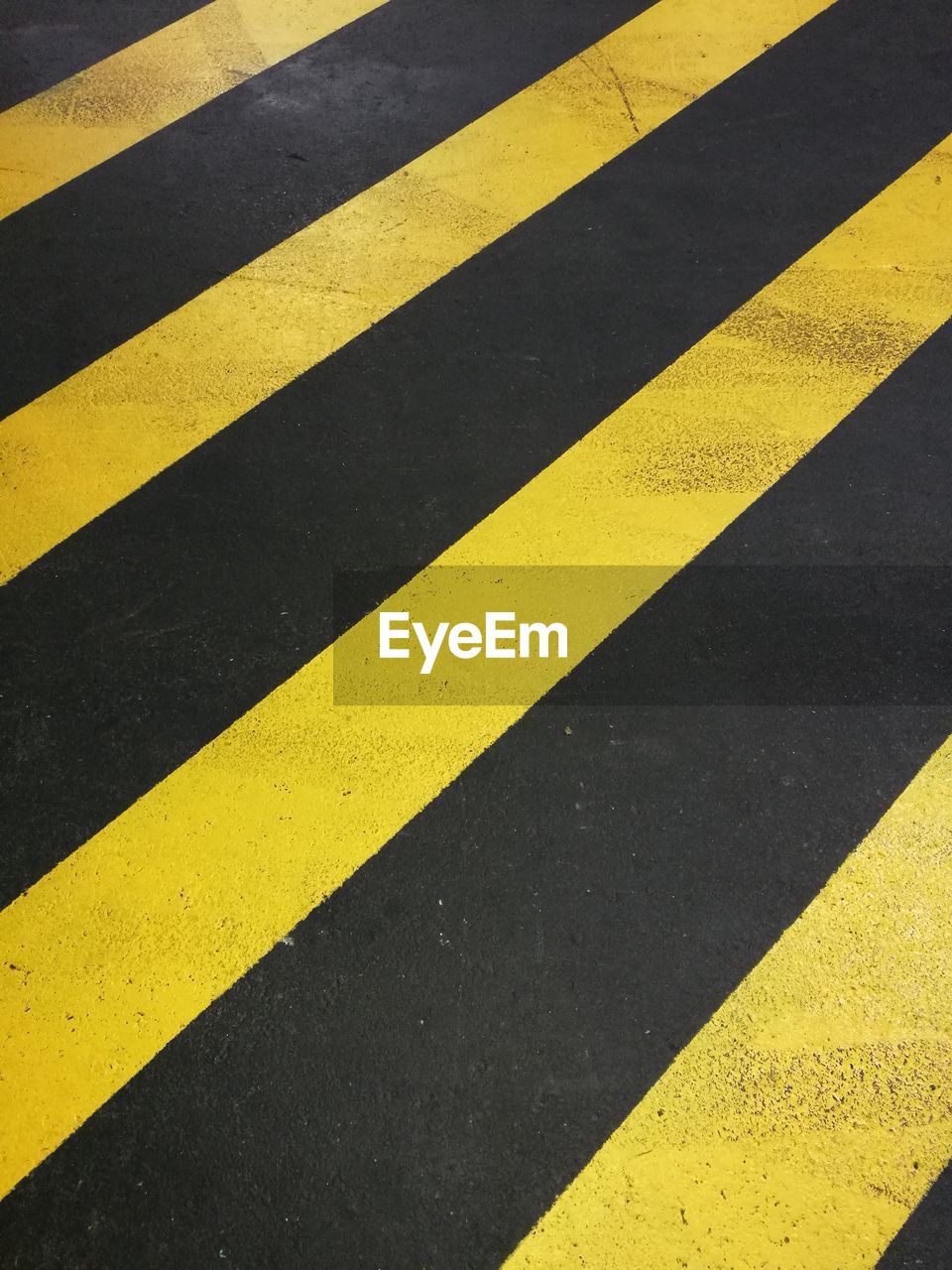 Close-up of yellow zebra crossing on road