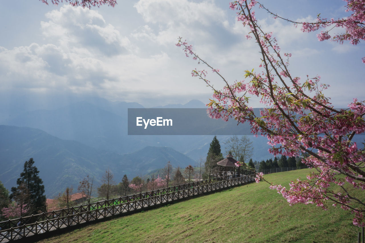 Scenic view of mountains against cloudy sky