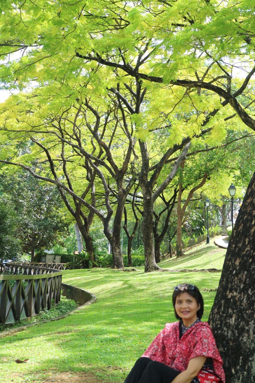 WOMAN STANDING IN PARK