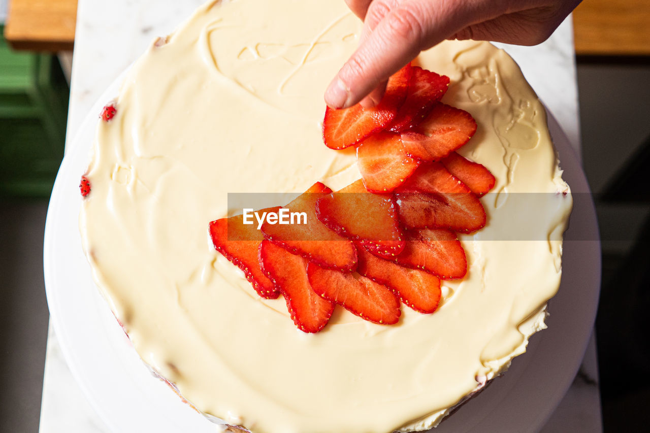 MIDSECTION OF PERSON HOLDING CAKE