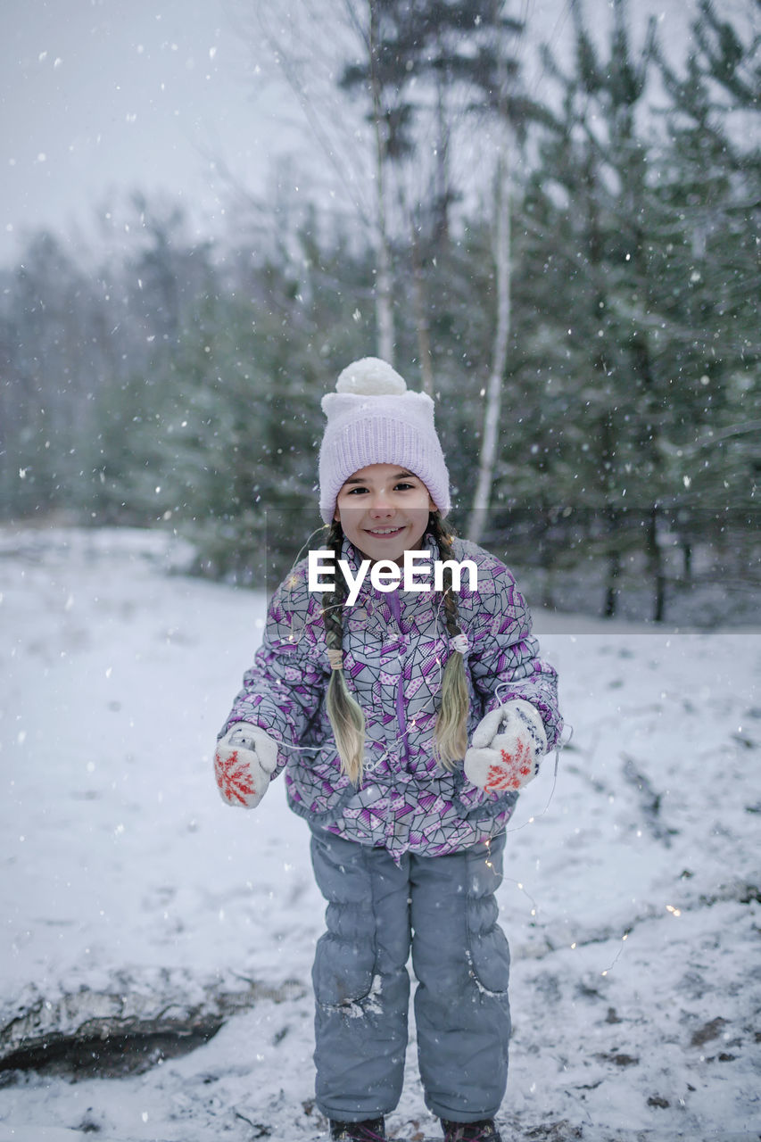 Cute girl standing in snow