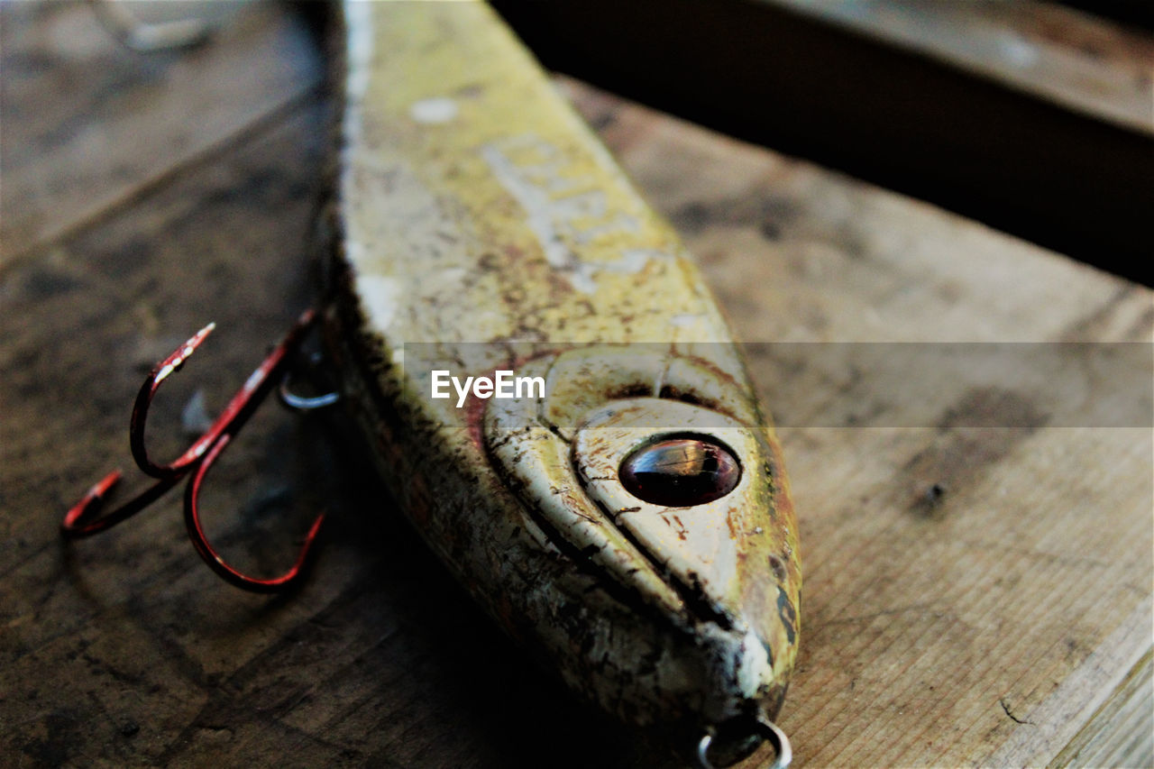 High angle view of old fishing lure on a wooden table