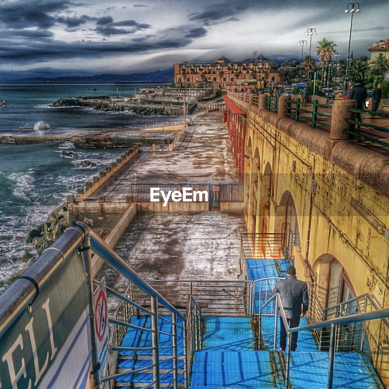 VIEW OF TOWN AGAINST CLOUDY SKY