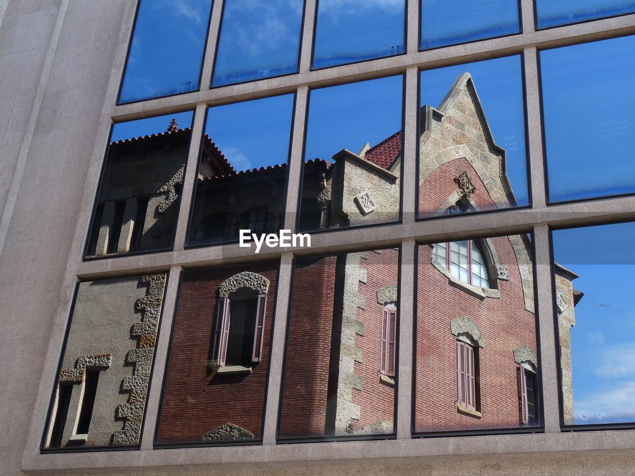 LOW ANGLE VIEW OF BUILT STRUCTURES AGAINST BLUE SKY