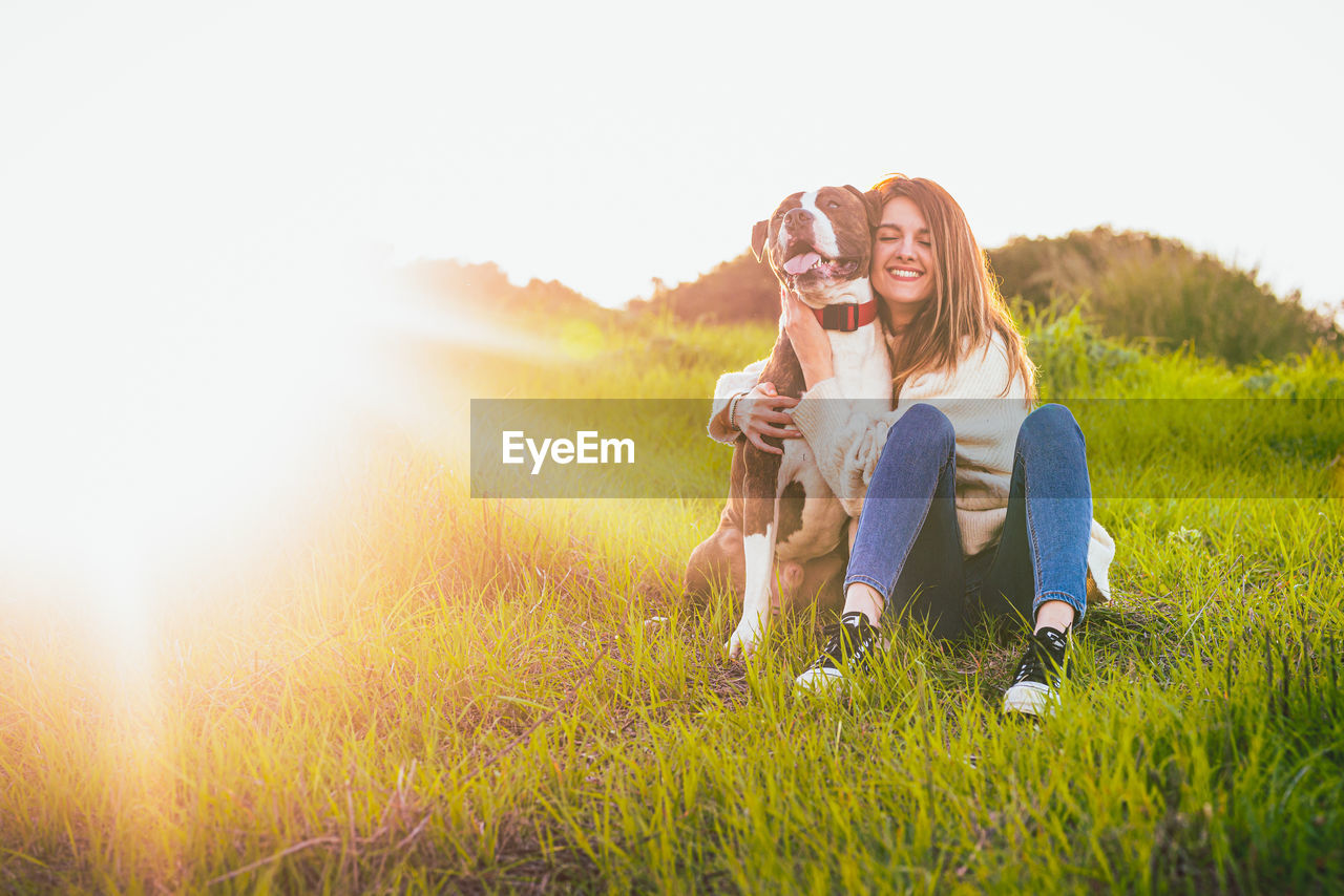 Woman with dog on field