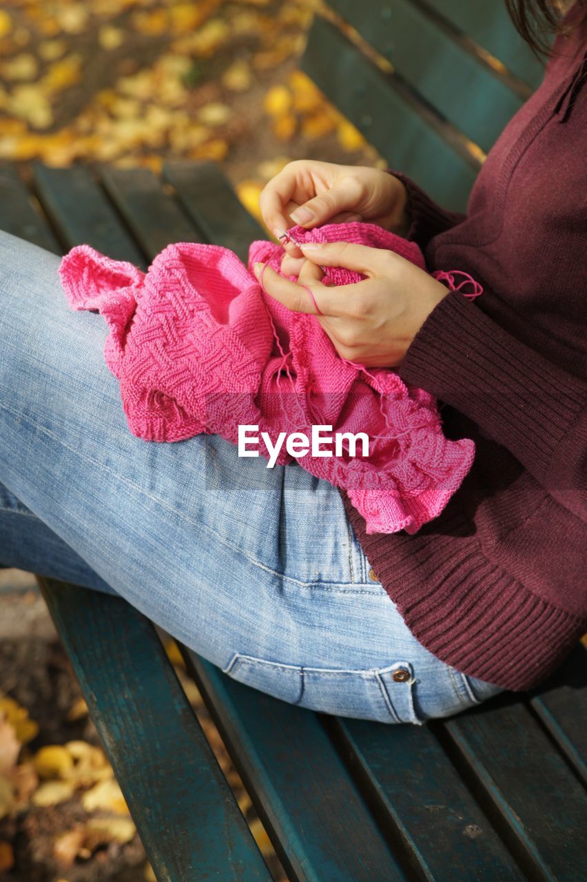 MIDSECTION OF WOMAN WITH PINK UMBRELLA