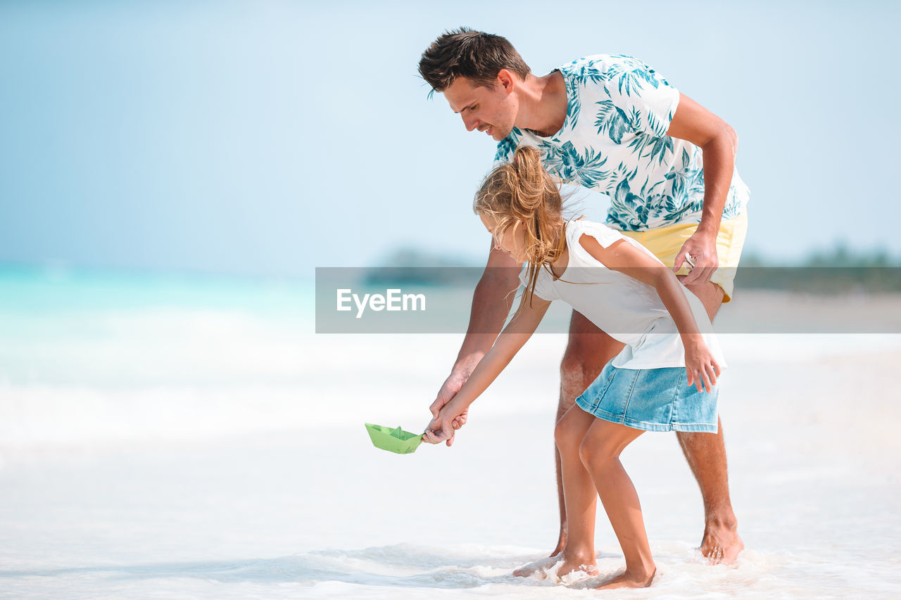 Father and daughter playing at beach