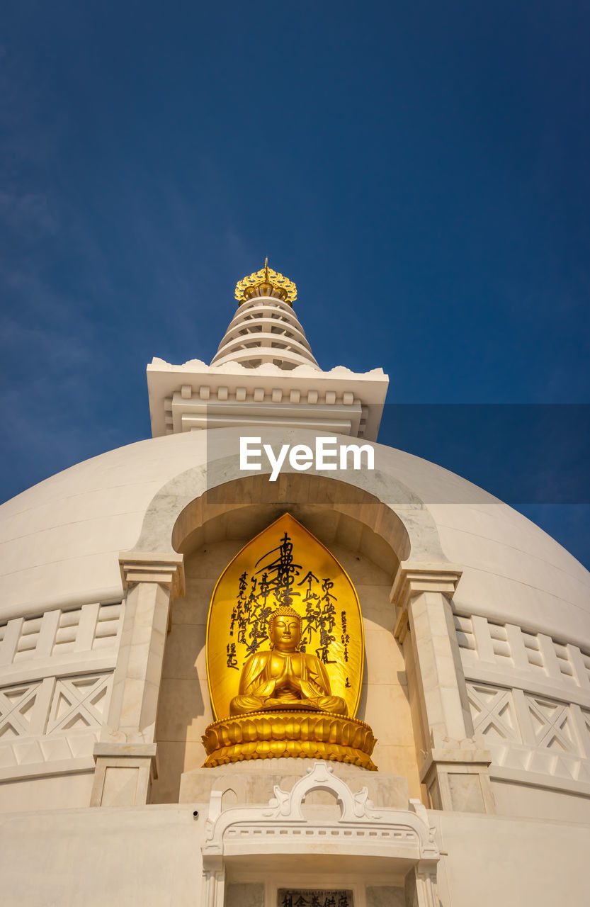 LOW ANGLE VIEW OF BELL TOWER AGAINST BLUE SKY